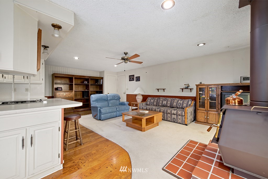 807 Union Street Northeast Renton, WA 98056 - Photo 7 of 38 a living room with furniture a rug and white walls