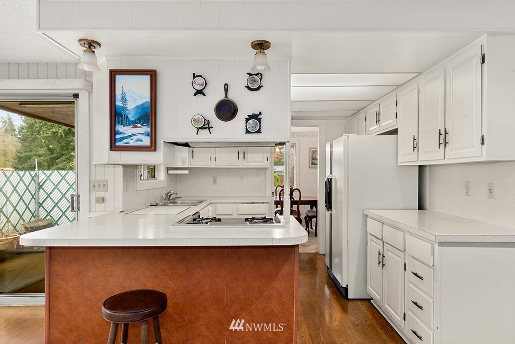 807 Union Street Northeast Renton, WA 98056 - Photo 8 of 38 a kitchen with stainless steel appliances a stove a sink and a refrigerator