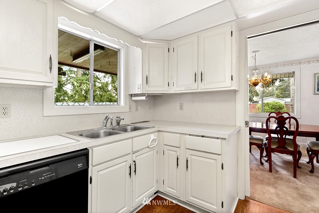 807 Union Street Northeast Renton, WA 98056 - Photo 10 of 38 a kitchen with white cabinets and window