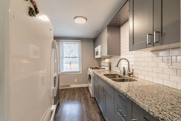 a kitchen with stainless steel appliances granite countertop a sink stove and cabinets