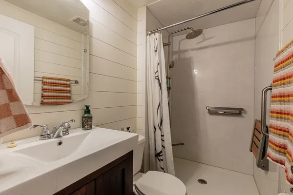a bathroom with a sink toilet and shower