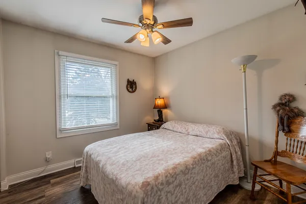 a bedroom with a bed and a chandelier