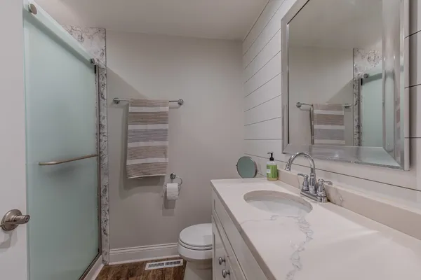 a bathroom with a sink toilet and shower