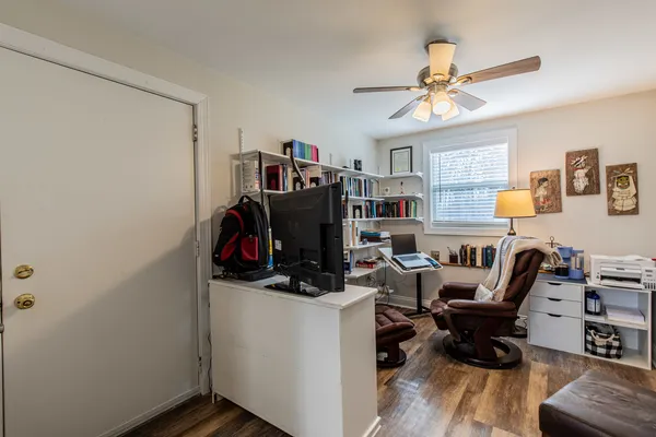 a view of a workspace with furniture and a window