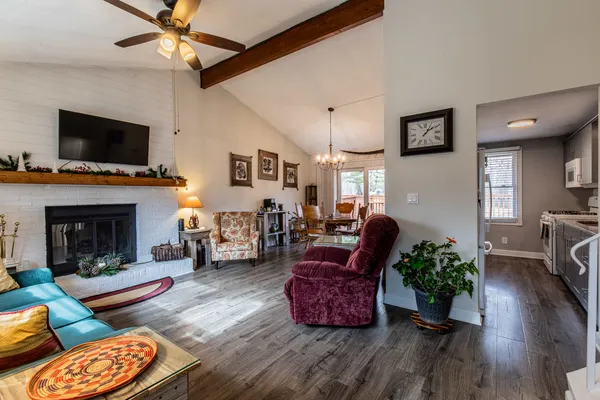 a living room with furniture fireplace and flat screen tv