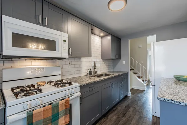 a kitchen with a stove a sink and a microwave