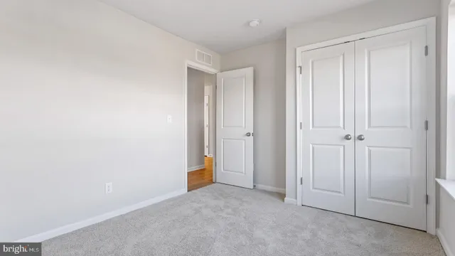 an empty room with closet area