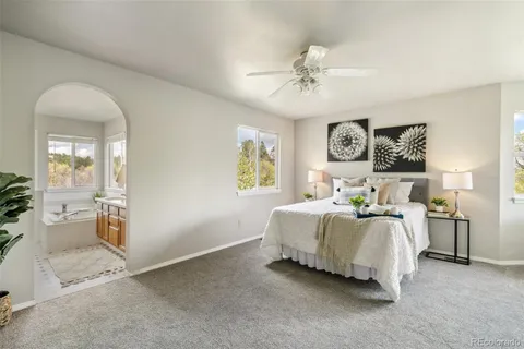 a bathroom with a granite countertop sink a toilet and a mirror