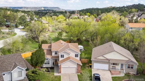 an aerial view of residential houses with outdoor space and lake view