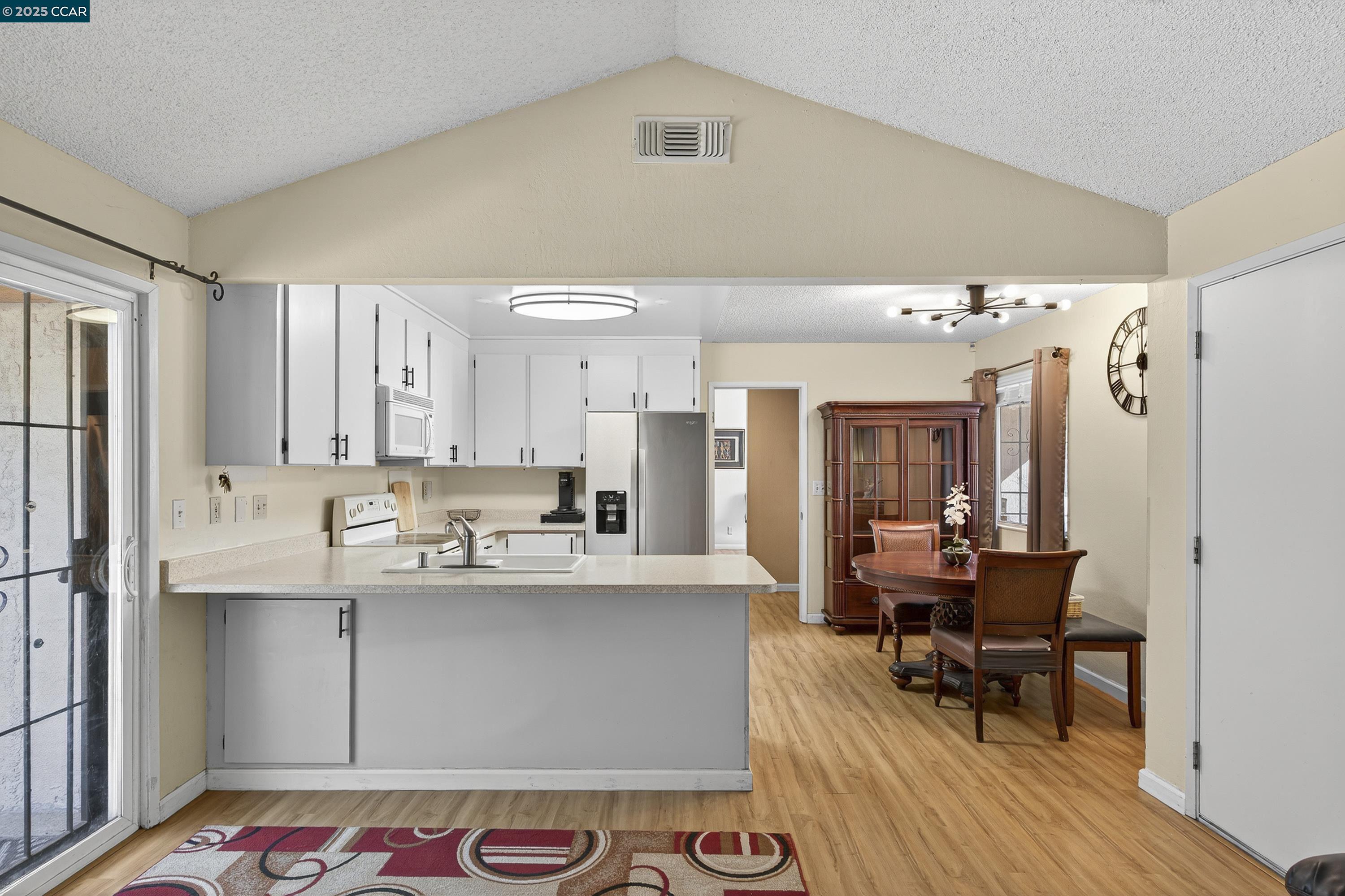 817 Ketch Court Rodeo, CA 94572 - Photo 11 of 45 a living room with granite countertop furniture and a dining table with wooden floor