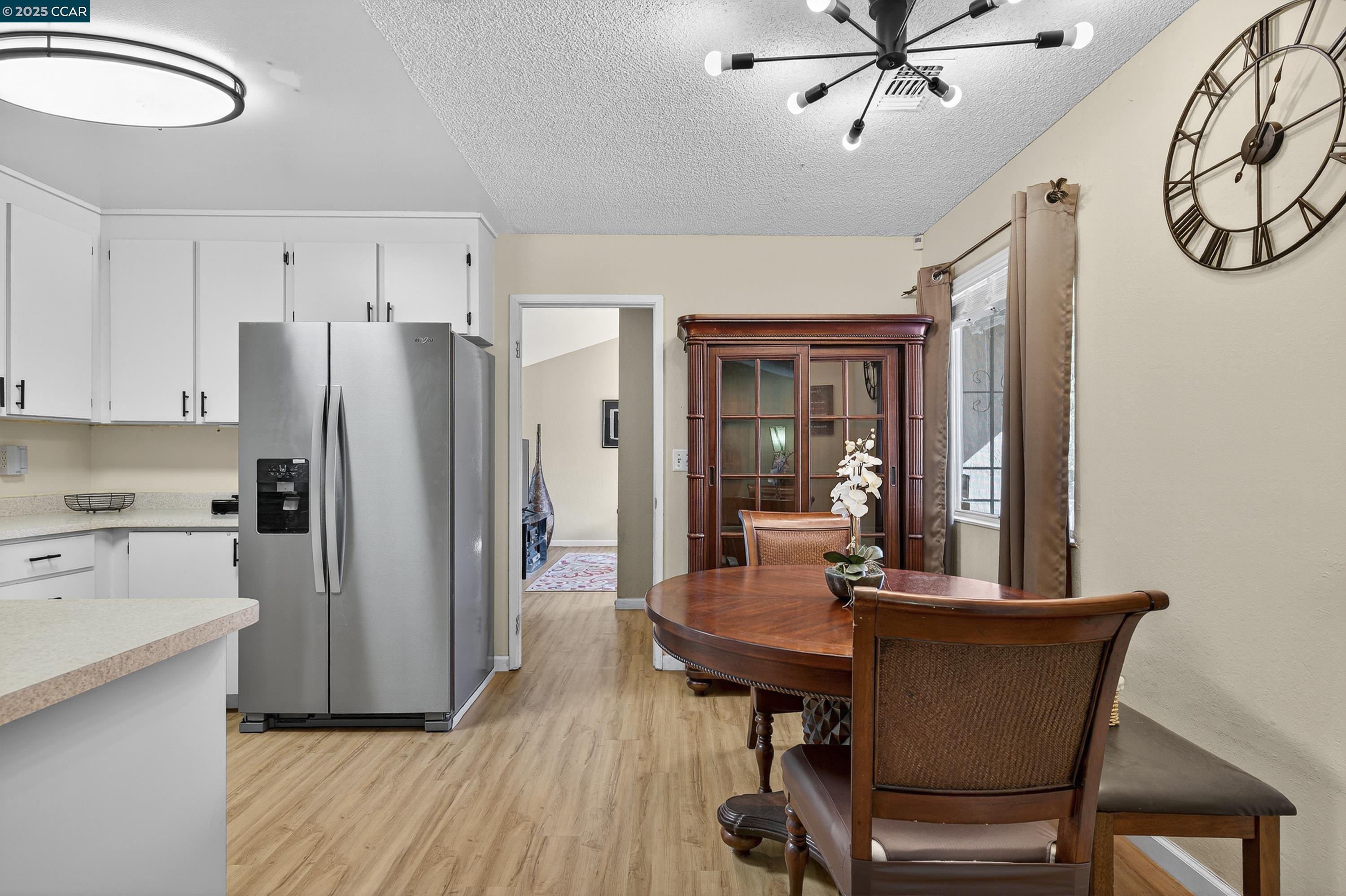 817 Ketch Court Rodeo, CA 94572 - Photo 18 of 45 a kitchen with stainless steel appliances a dining table chairs and chandelier