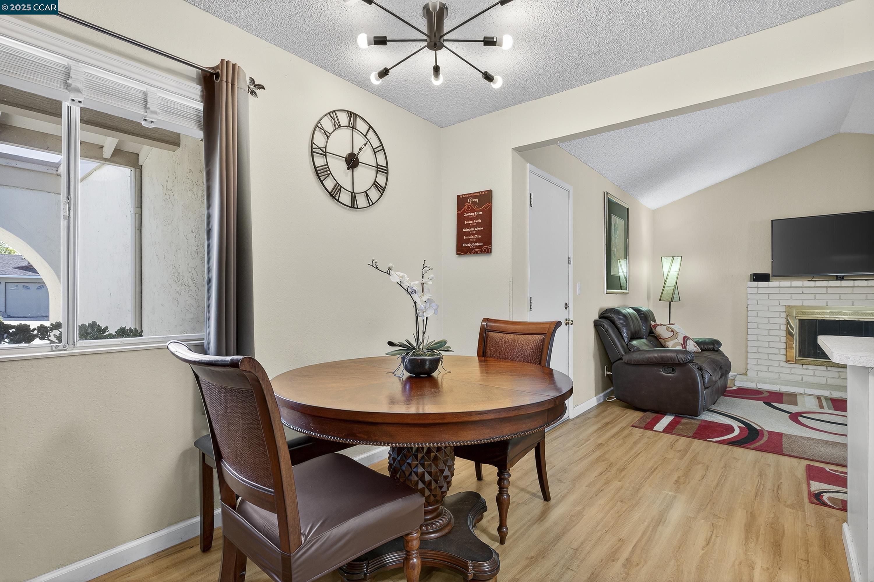 817 Ketch Court Rodeo, CA 94572 - Photo 19 of 45 a living room with furniture a clock and a flat screen tv