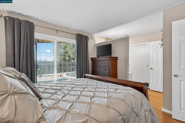 a bedroom with a bed and a large window