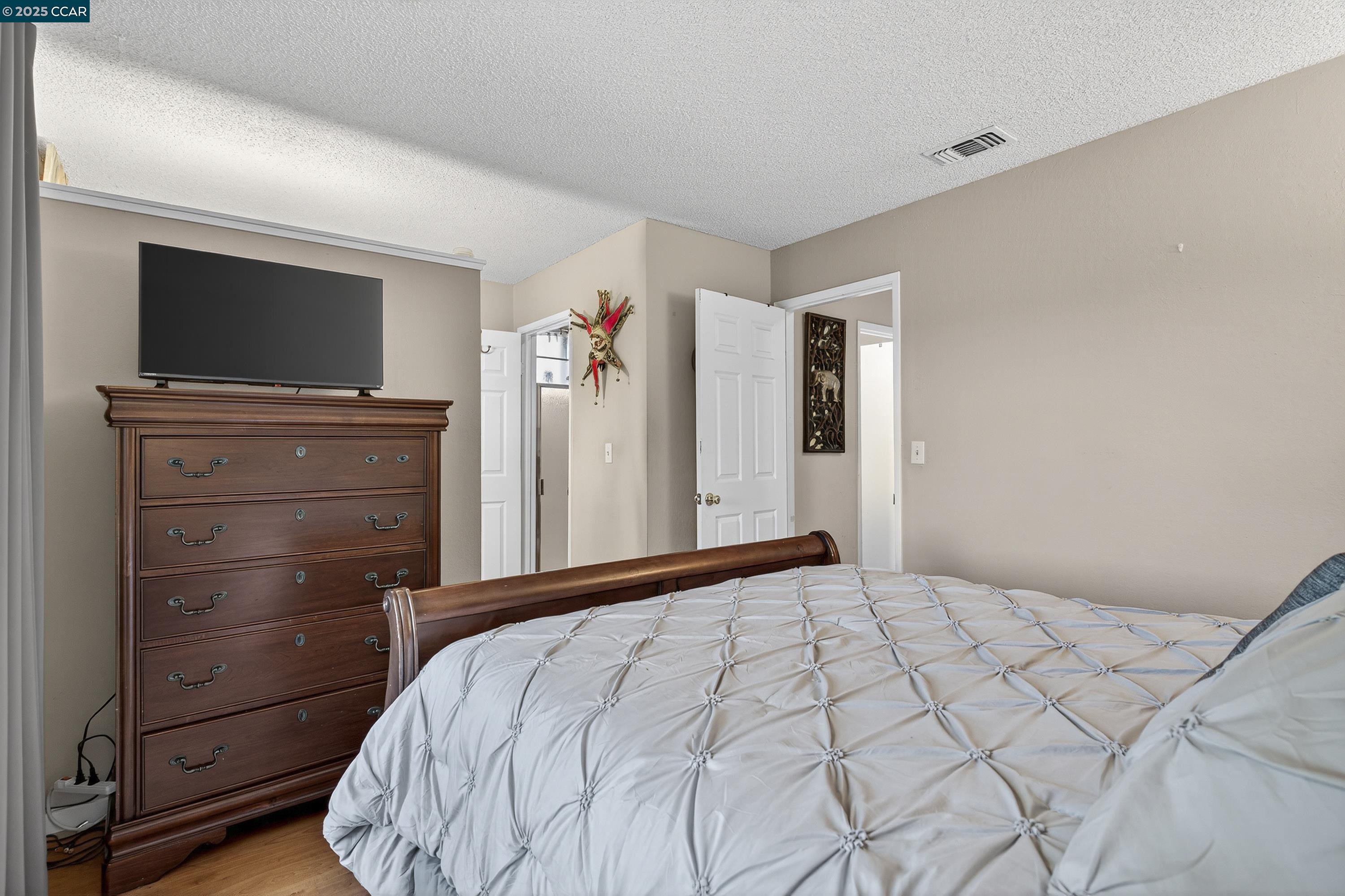 817 Ketch Court Rodeo, CA 94572 - Photo 24 of 45 a bedroom with a bed and a flat screen tv