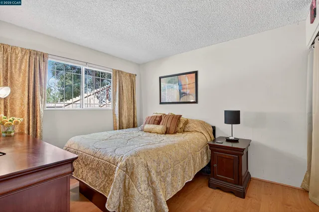 a bedroom with a bed and a tv on the dresser