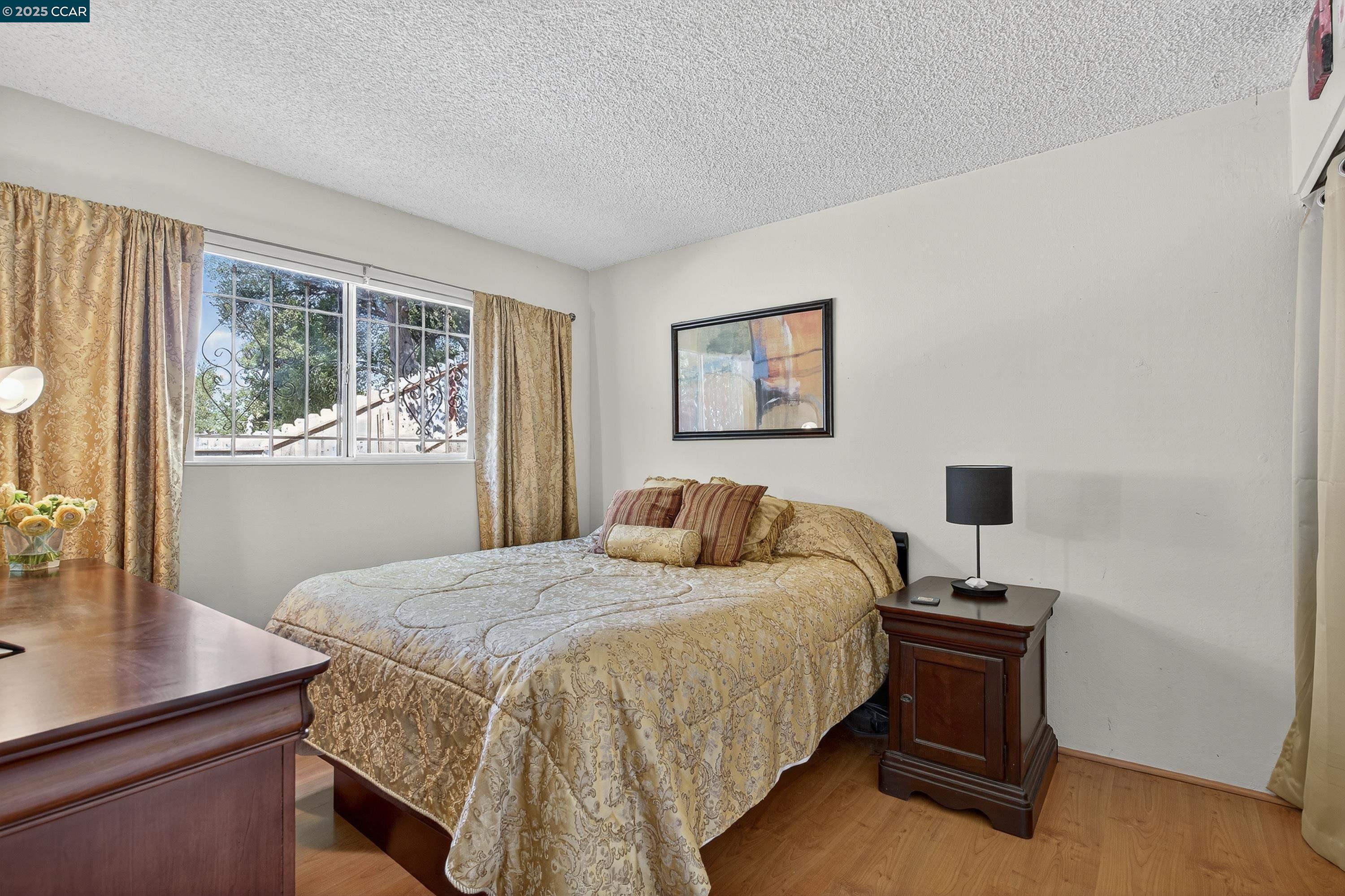 817 Ketch Court Rodeo, CA 94572 - Photo 30 of 45 a bedroom with a bed and a table in it