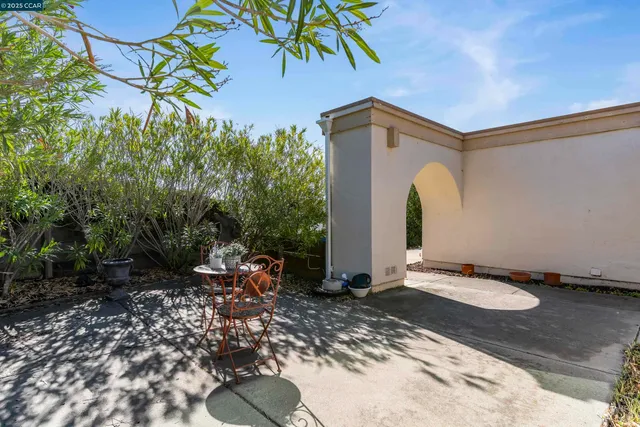 a backyard of a house with table and chairs