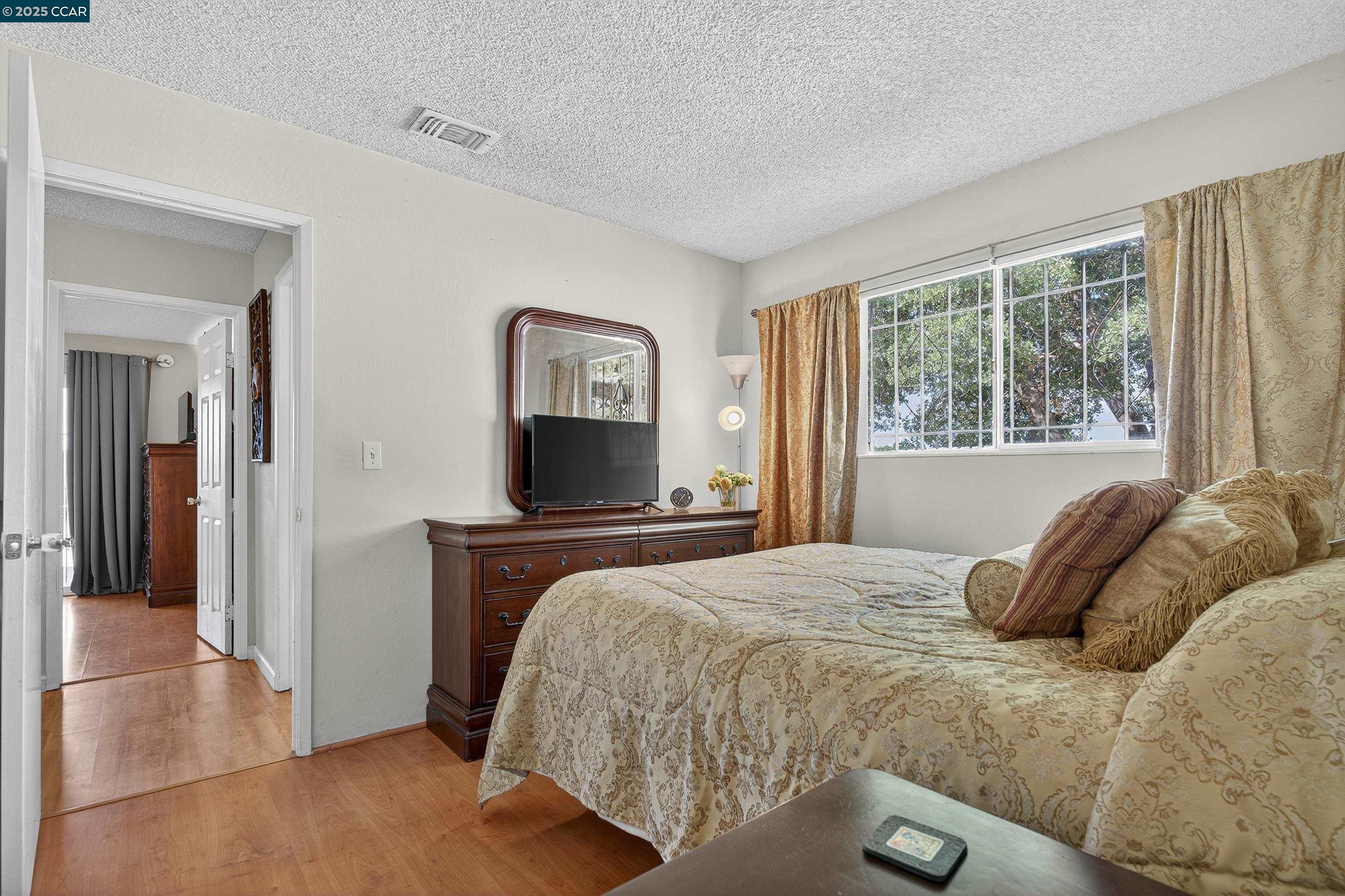 817 Ketch Court Rodeo, CA 94572 - Photo 31 of 45 a bedroom with a bed and a tv on the dresser