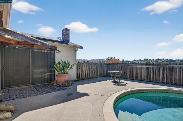 a view of a roof deck with table and chairs