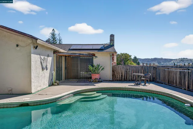 a view of a swimming pools under an umbrella