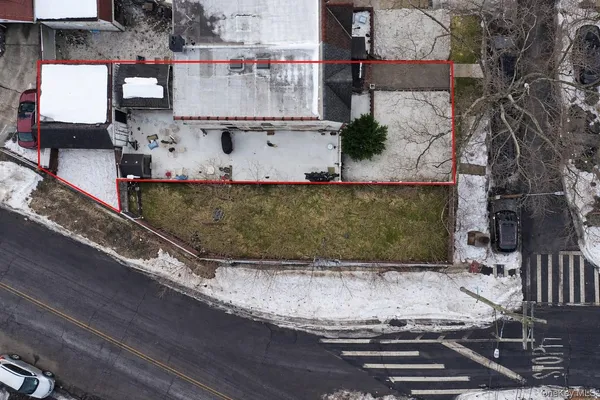 an aerial view of a house with a yard