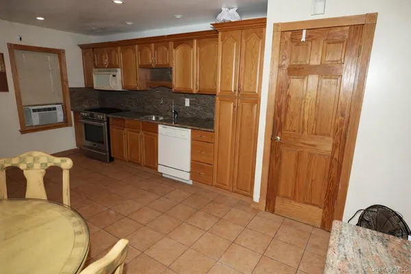 a kitchen with stainless steel appliances granite countertop a refrigerator and a stove