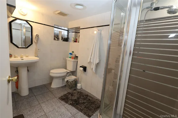a bathroom with a toilet a sink and shower