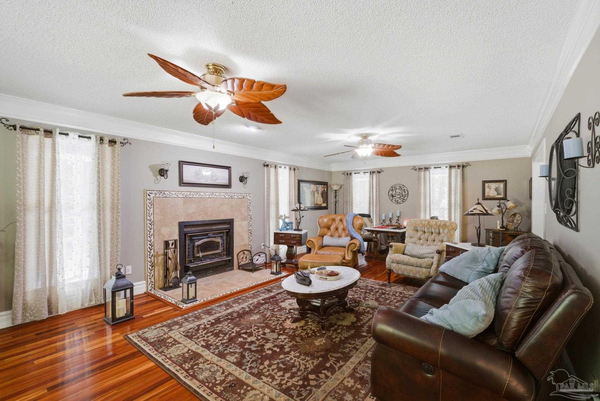 6930 Summit Way Milton, FL 32570 - Photo 10 of 71 a living room with furniture a fireplace and a window