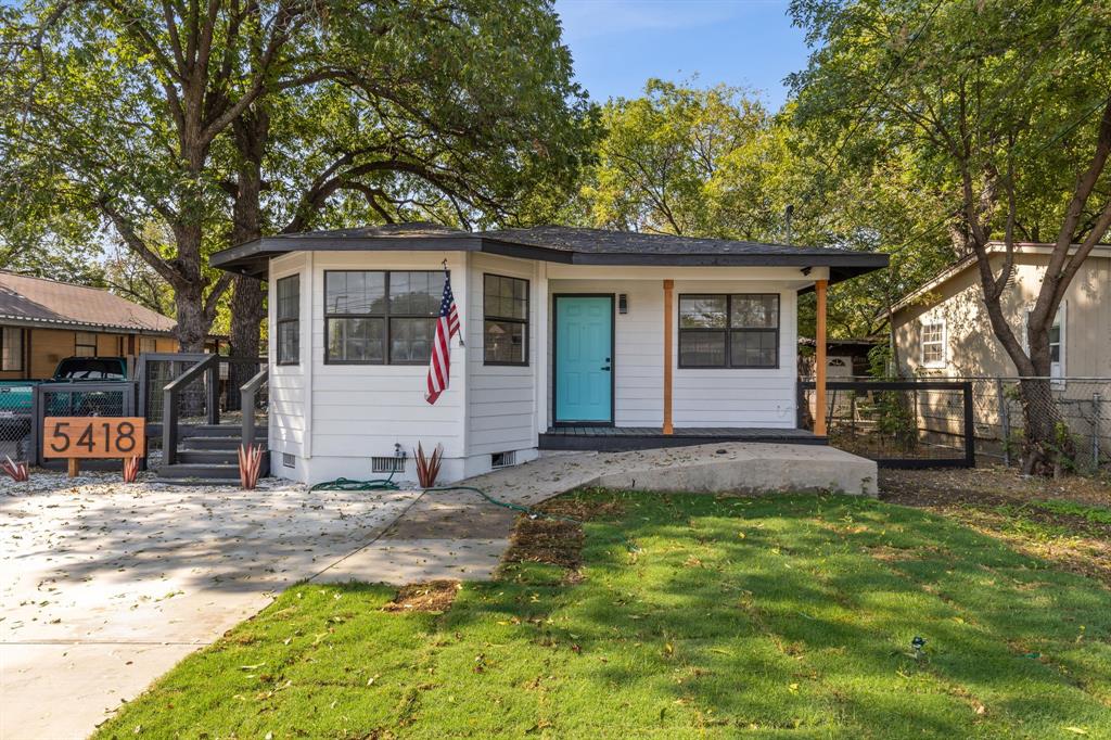 a view of a house with a yard and tree s
