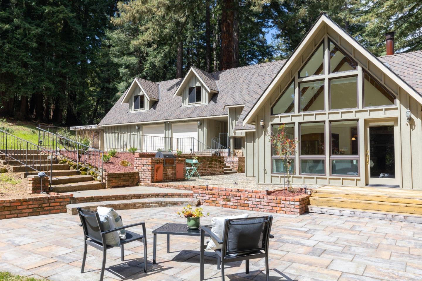 a front view of a house with patio furniture and garden