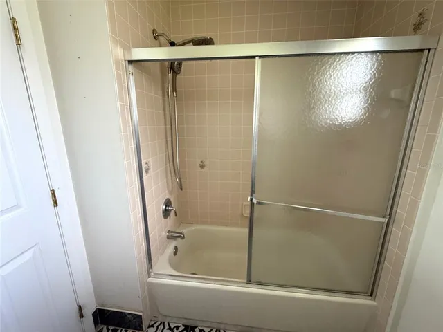 a bathroom with a glass shower door