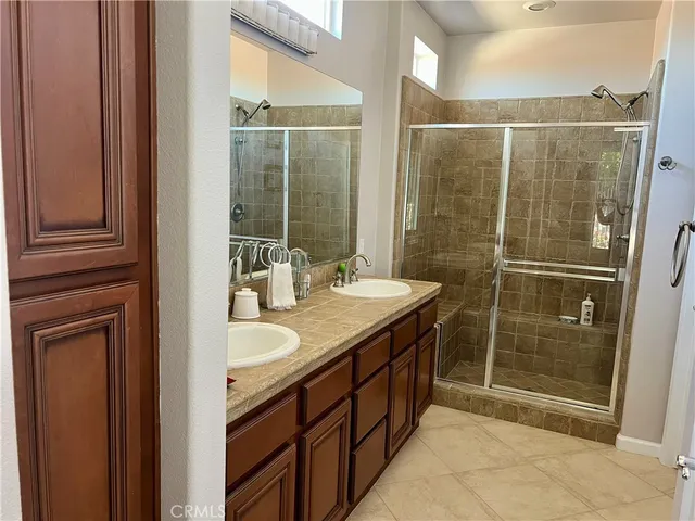 a bathroom with a double vanity sink and a mirror