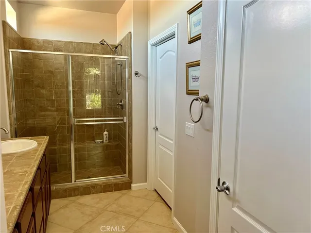 a bathroom with a glass shower door