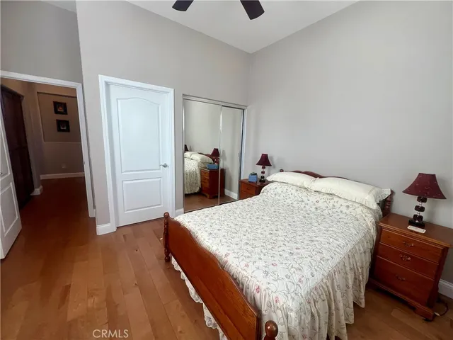 a bed sitting in a bedroom and wooden floor