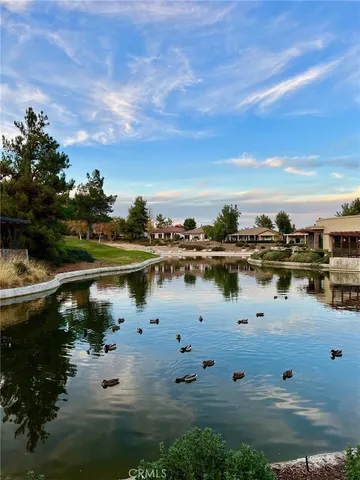 a backyard of a house with lots of green space and lake view