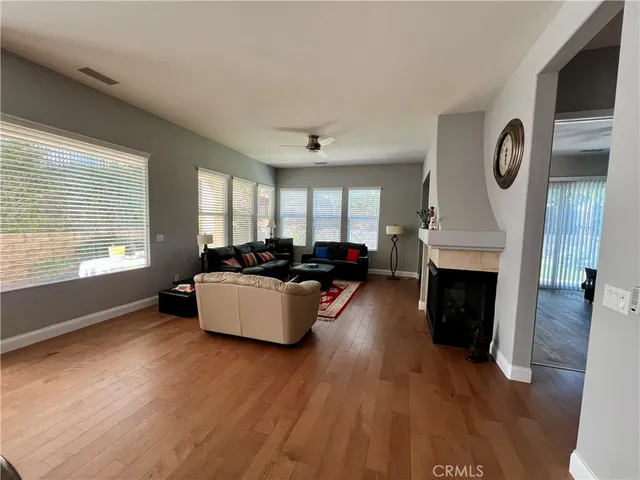 a living room with furniture fireplace and window