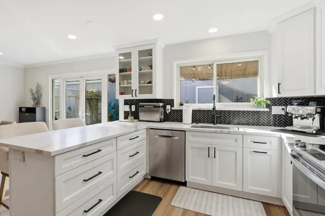 a kitchen with a sink stove and microwave