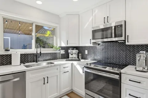 a kitchen with a refrigerator stove and cabinets