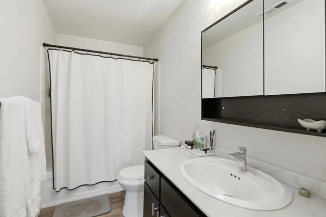 a bedroom with a large bed and a window