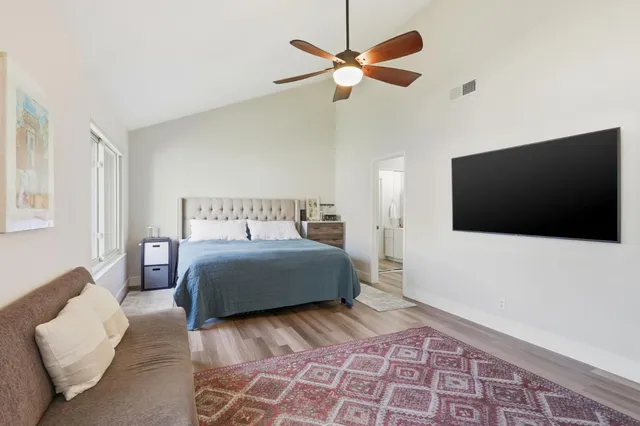 a bedroom with a large bed and a window