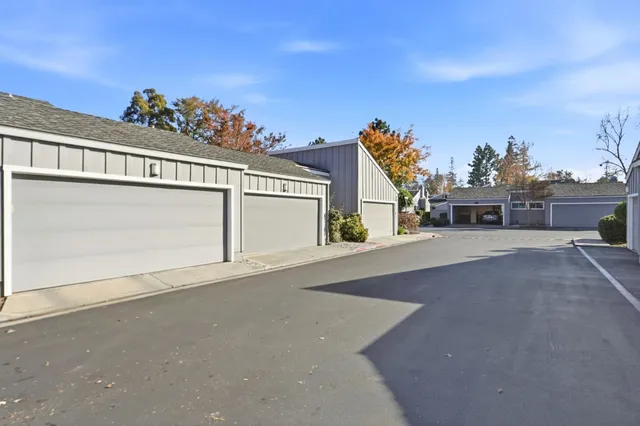 a front view of a house with a garden and plants