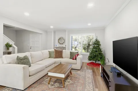a living room with furniture and wooden floor