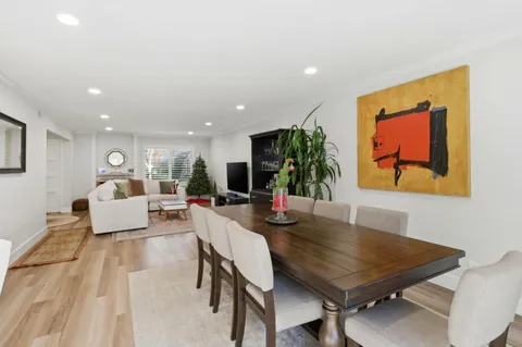 a view of a dining room with furniture and a potted plant