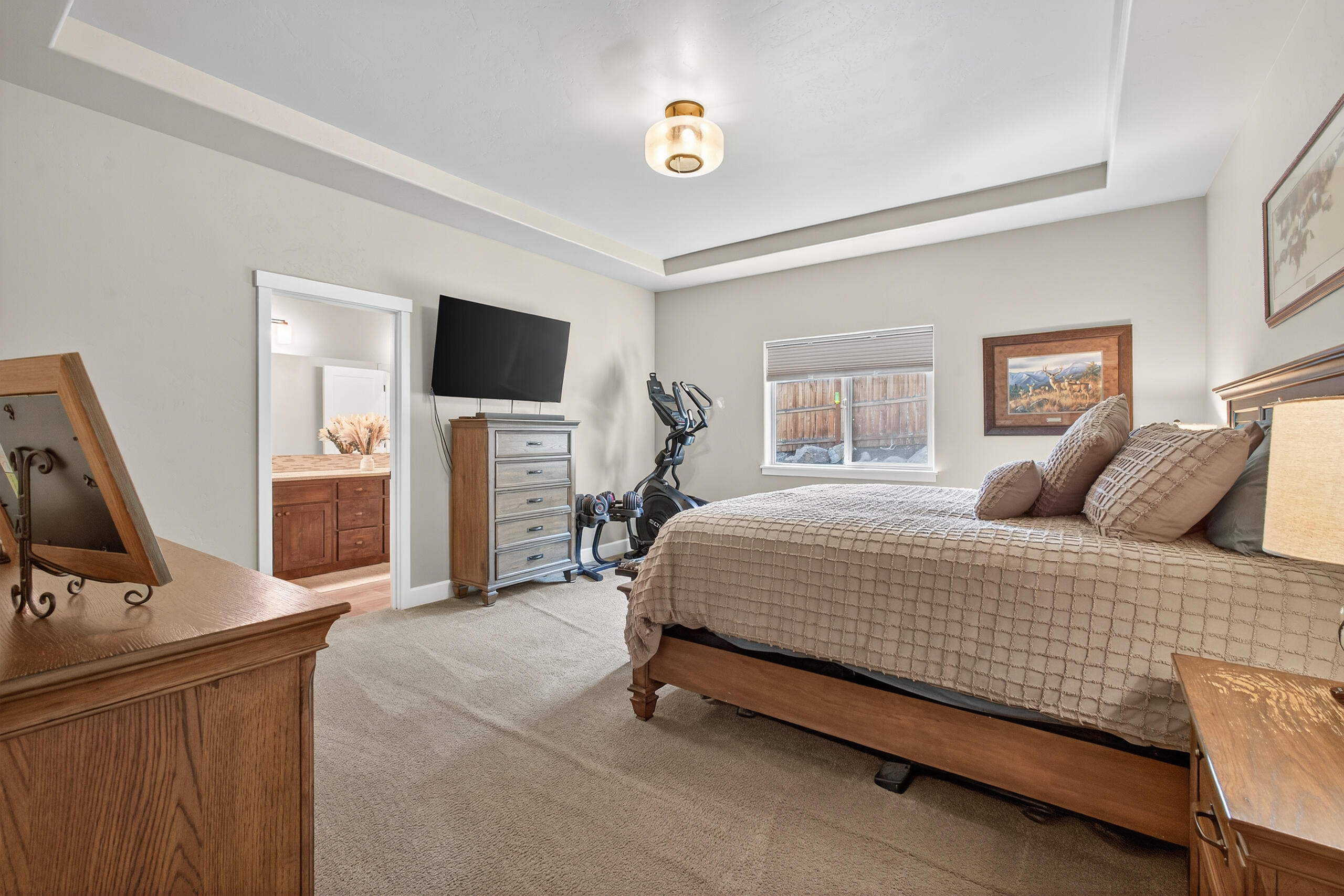 2793 Southwest 33rd Street Redmond, OR 97756 - Photo 17 of 44 a bedroom with a bed a flat screen tv and dresser