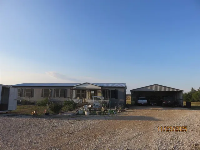 a couple of table and chairs under an umbrella
