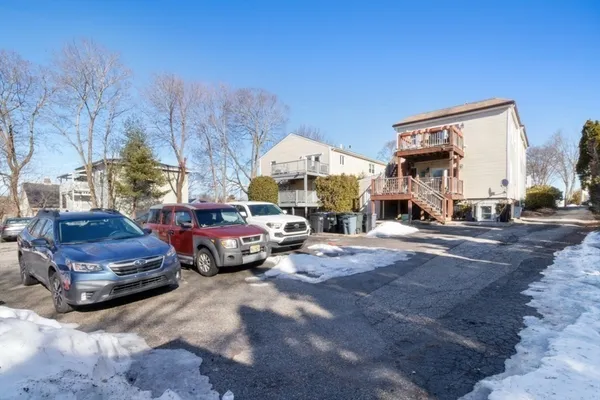 a view of cars parked in front of a house
