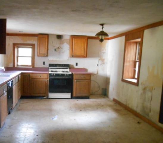 17294 Sumner Road Pecatonica, IL 61063 - Photo 7 of 10 a kitchen with stainless steel appliances granite countertop a stove a sink and a microwave