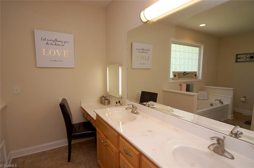 6205 Monnett Road Julian, NC 27283 - Photo 16 of 30 Private master bath. Dual sinks, wonderful counter space and vanity seating.