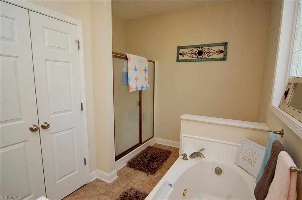 6205 Monnett Road Julian, NC 27283 - Photo 17 of 30 The master bath also offers a jetted tub, separate shower and ample linen storage.