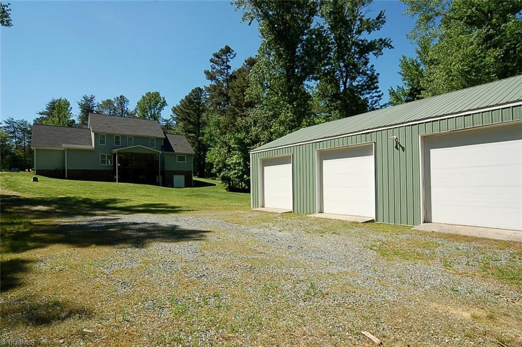 6205 Monnett Road Julian, NC 27283 - Photo 29 of 30 A view of the home and garage shop building.